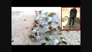 راه رفتن یک شعبده باز ایرانی روی شیشه های شکسته شده